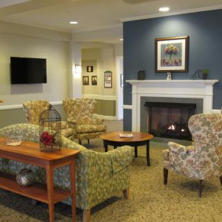 A cozy living room with a fireplace and comfortable seating.