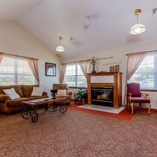 A cozy living room with a fireplace and comfortable seating.