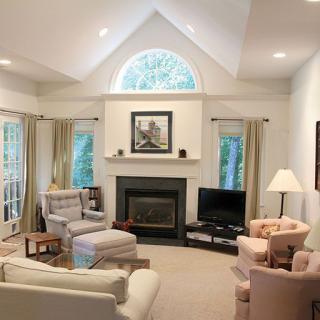 A cozy living room with elegant furniture, a fireplace, and soft lighting.