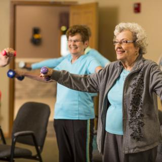 Seniors participating in a group exercise session indoors.