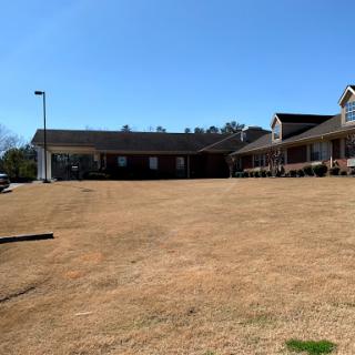 A view of a commercial building complex under a clear blue sky.