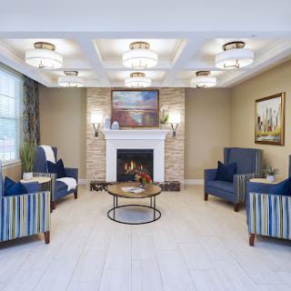 A cozy and modern living room featuring a fireplace, comfortable seating, and elegant lighting.