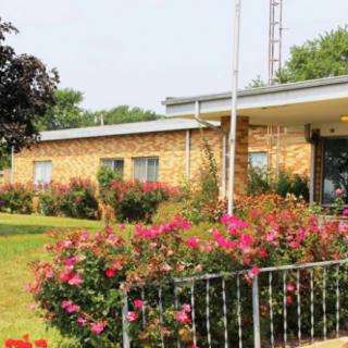 A building surrounded by a garden with blooming flowers.