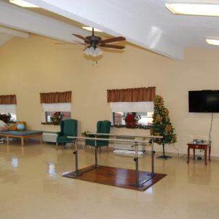 A therapy room equipped with exercise equipment in a healthcare facility.