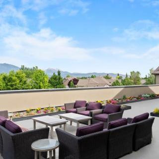 A spacious patio with comfortable seating and a scenic mountain view.