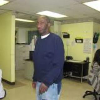 A person standing in an office environment.