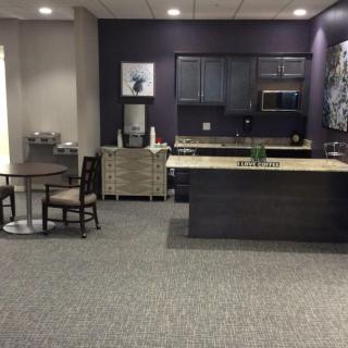 A modern kitchen and dining area featuring sleek cabinetry and furnishings.