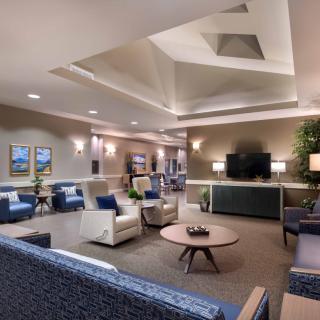 A modern living room with comfortable seating and a television.