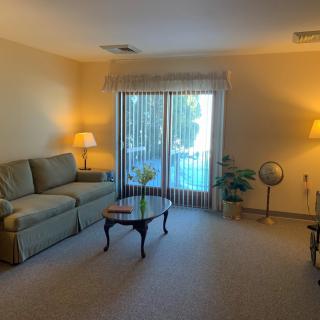 A cozy living room with a sofa, coffee table, and warm lighting.