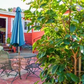 A cozy patio setup with garden furniture and lush greenery.