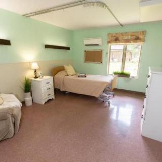 A spacious and calming hospital room designed for patient comfort and care.