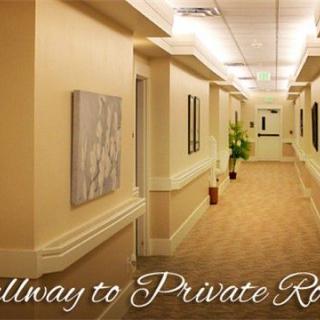 A well-lit hallway leading to private rooms.