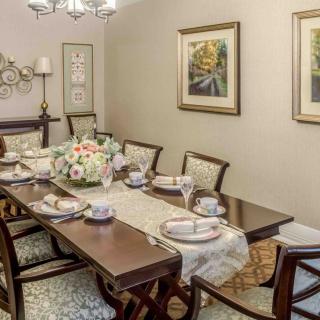 An elegantly set dining room with classic furniture and tasteful decor.