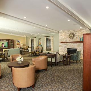 A cozy lounge area with comfortable seating and a fireplace.