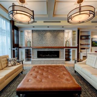 A modern living room with stylish furniture and a cozy fireplace.