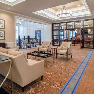 A modern and luxurious hotel lobby with comfortable seating arrangements and elegant lighting.