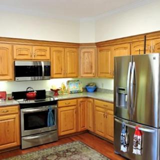 A traditional kitchen with wooden cabinets and stainless steel appliances.