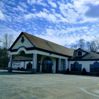 A building with a distinctive architectural style under a cloudy sky.