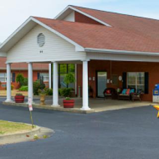 A welcoming entrance to a residential facility with well-maintained landscaping.