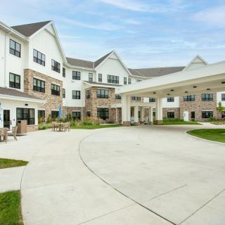 Exterior view of a multi-story residential building with landscaped surroundings.