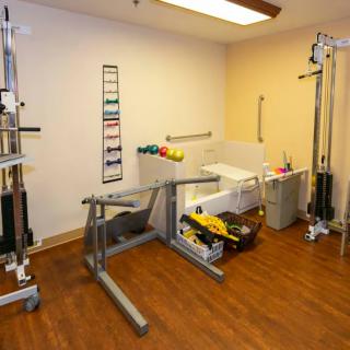 A physical therapy room equipped with various rehabilitation tools and exercise equipment.