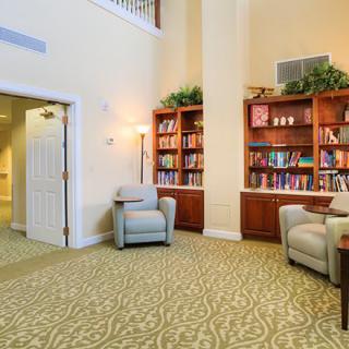 A cozy library corner with comfortable armchairs and well-stocked bookshelves.