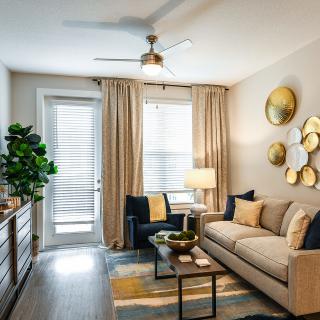A well-decorated living room with a cozy sofa, modern armchair, and stylish wall decor.