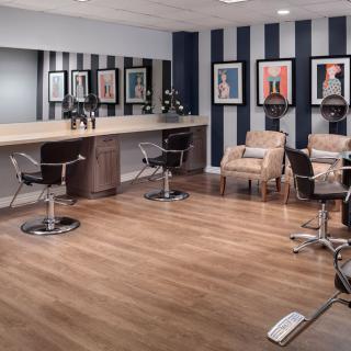A modern hair salon with stylish decor and comfortable seating.