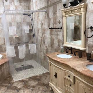 A stylish bathroom with a walk-in shower and double sink vanity.