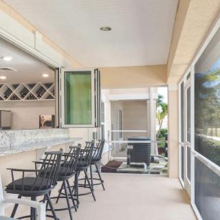 A modern patio with bar seating and open access to the kitchen area.