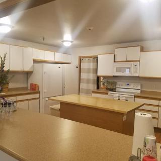 A modern kitchen interior with white cabinets and a central island.
