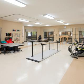 A well-lit dance and rehabilitation studio featuring exercise equipment and barres.