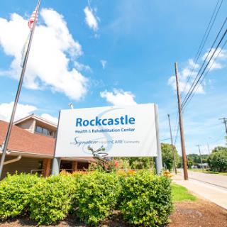 Rockcastle Health Center sign featuring clear skies and lush greenery.