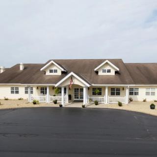 A large residential house with a wide porch and multiple windows.