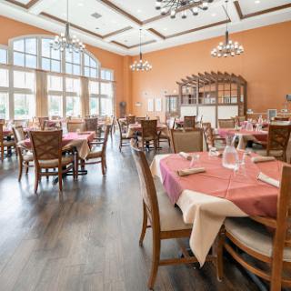 A beautifully arranged dining area in a restaurant, featuring elegant tables and warm decor.