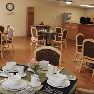 A dining room with neatly set tables and chairs, ready for guests.