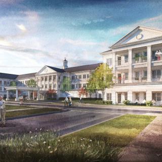 A modern medical facility with an entrance for emergency vehicles and landscaped surroundings.