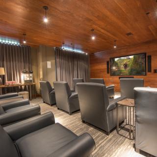 A modern home theater with comfortable seating and a large screen.