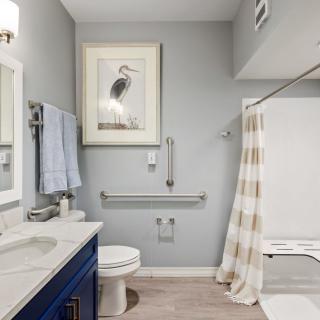A modern bathroom interior with a sink, toilet, and shower area.