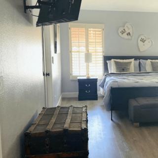 A modern bedroom with a wall-mounted TV and stylish decor.