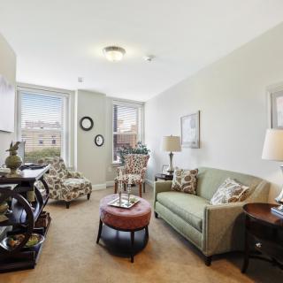 A cozy living room with a sofa, coffee table, and decorative elements.