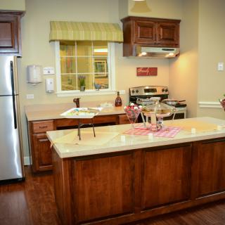 A modern kitchen with wooden cabinets and a central island.