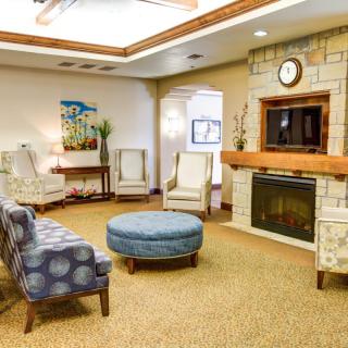 A cozy living room with a fireplace and comfortable seating.