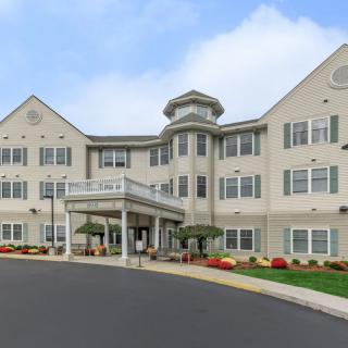 A large residential building with a landscaped exterior, possibly an assisted living or senior care facility.