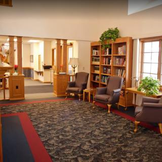A cozy library interior featuring comfortable seating and bookshelves.