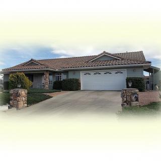 A suburban residential house with a two-car garage and driveway.