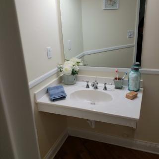 A tidy bathroom sink area with decorative elements.