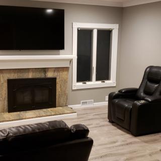 A modern living room with a fireplace, television, and comfortable seating.