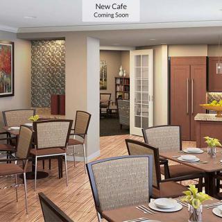 A modern cafe interior featuring tables and chairs, with a 'New Cafe Coming Soon' sign.