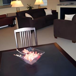 A cozy living room with sofas, a chair, and a table with decorative items.